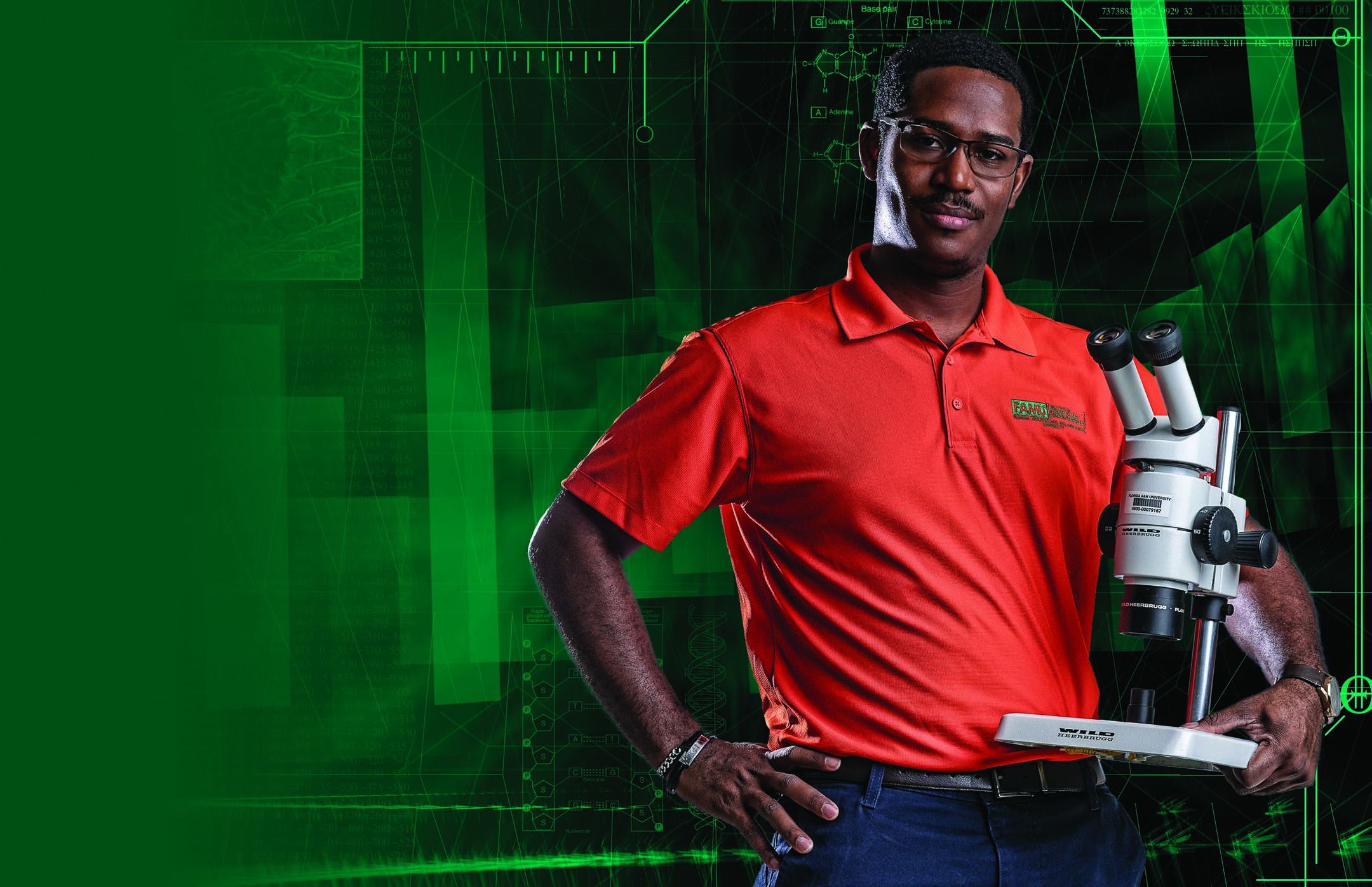 Perier, wearing a TAMU collared shirt, stands with a microscope on his hip