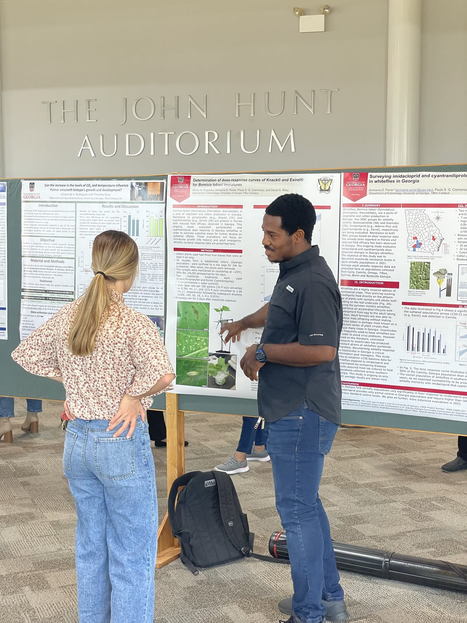 Perier explains his research to a woman examining his poster