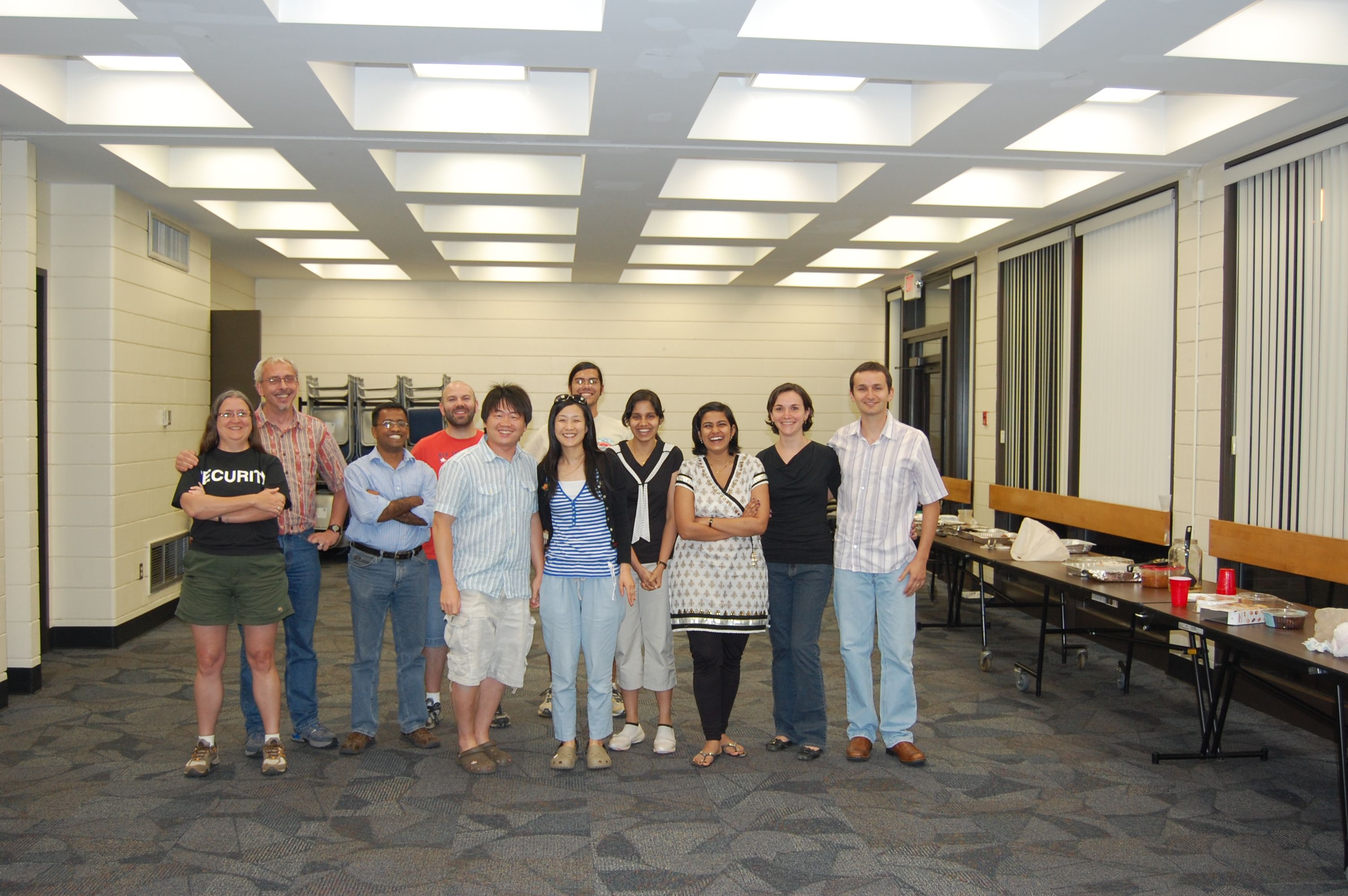 Jongyun Kim's farewell party at UGA, which included members of the horticulture department and their families in a carpeted room with a long table for refreshments.