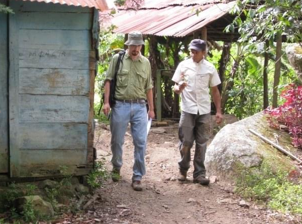 Lee Gross walks with a coffee farmer in the Dominican Republic.