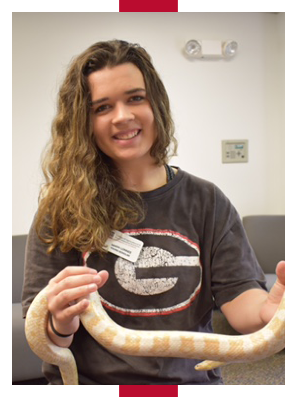 Lonnee holds a large yellow and white snake