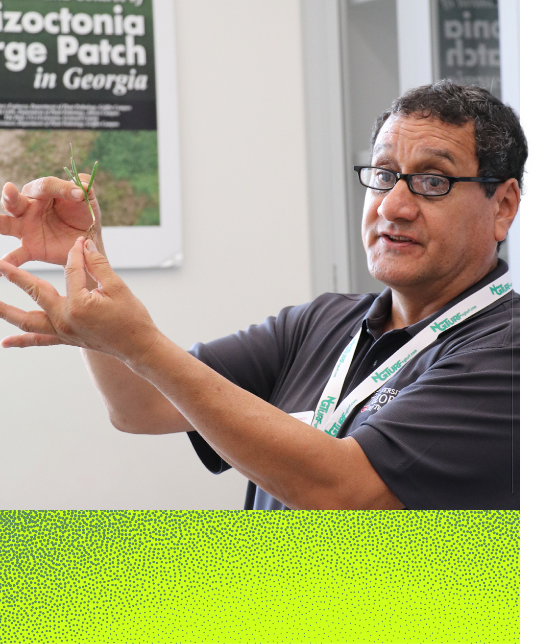 Alfredo Martinez-Espinoza holds up a blade of grass