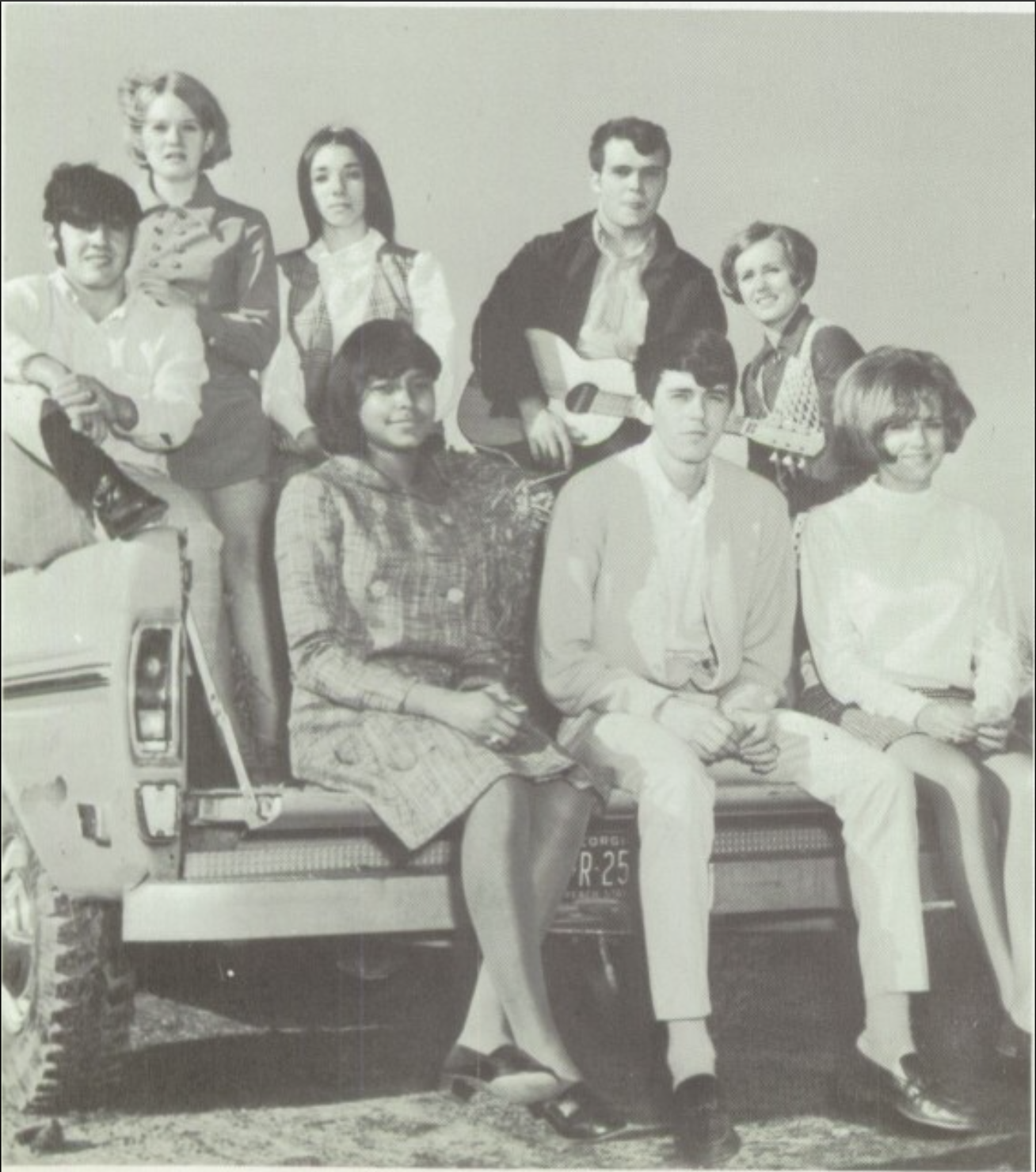 Linda Glanton Early sits in the bed of a pickup truck with seven other teenagers. She is the only Black woman.