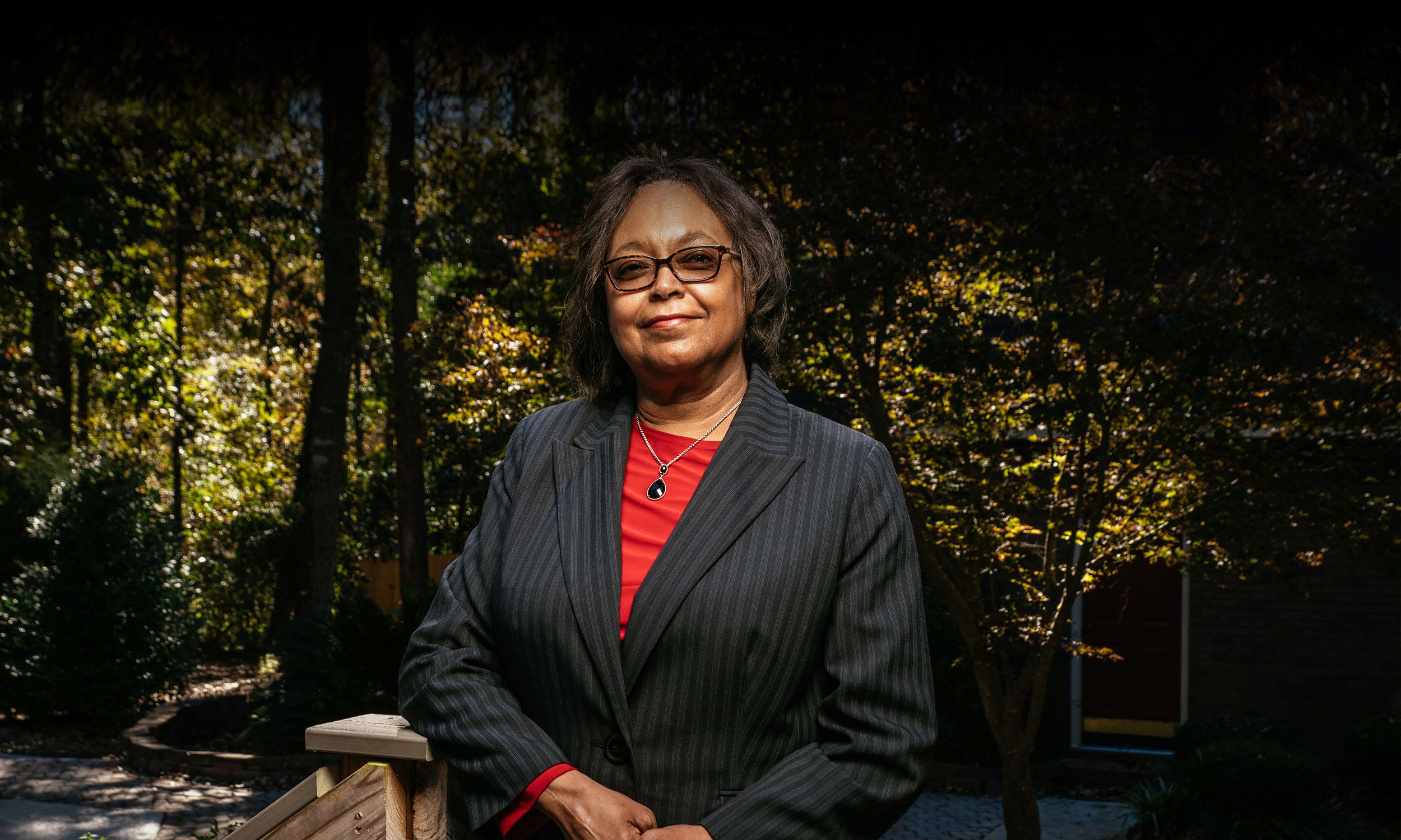 Linda Glanton Early at her home in Byron, Georgia, where she stands on a back porch.