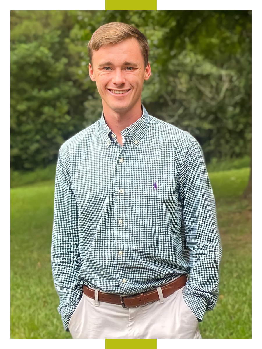 Lucas Brock stands with his hands in his pockets in an outdoor setting.
