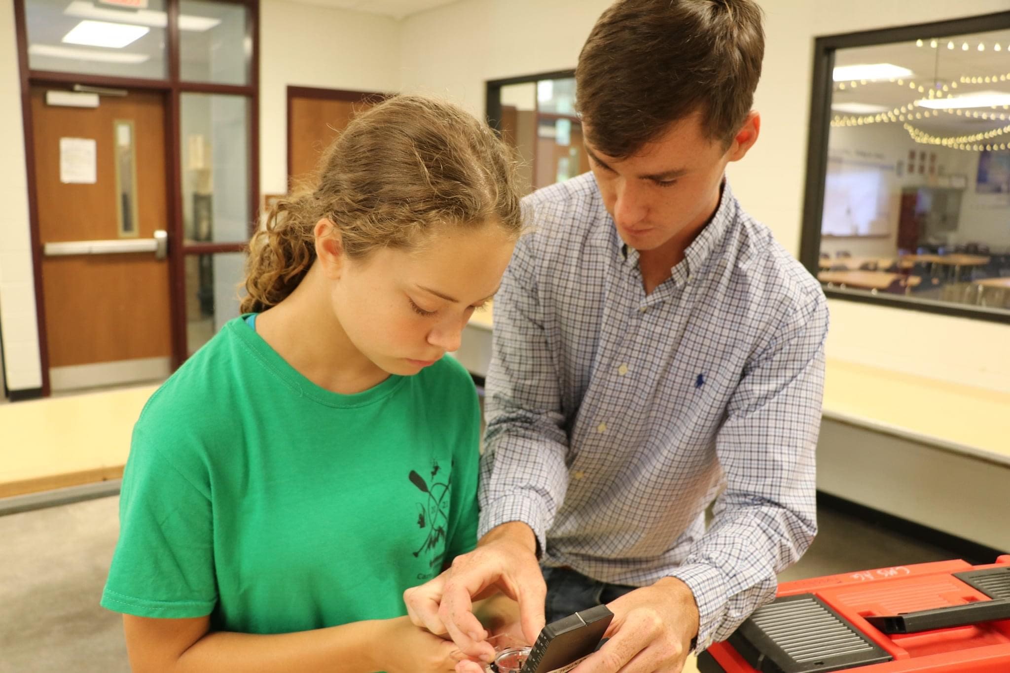 Lucas Brock instructs an individual student in a classroom setting.