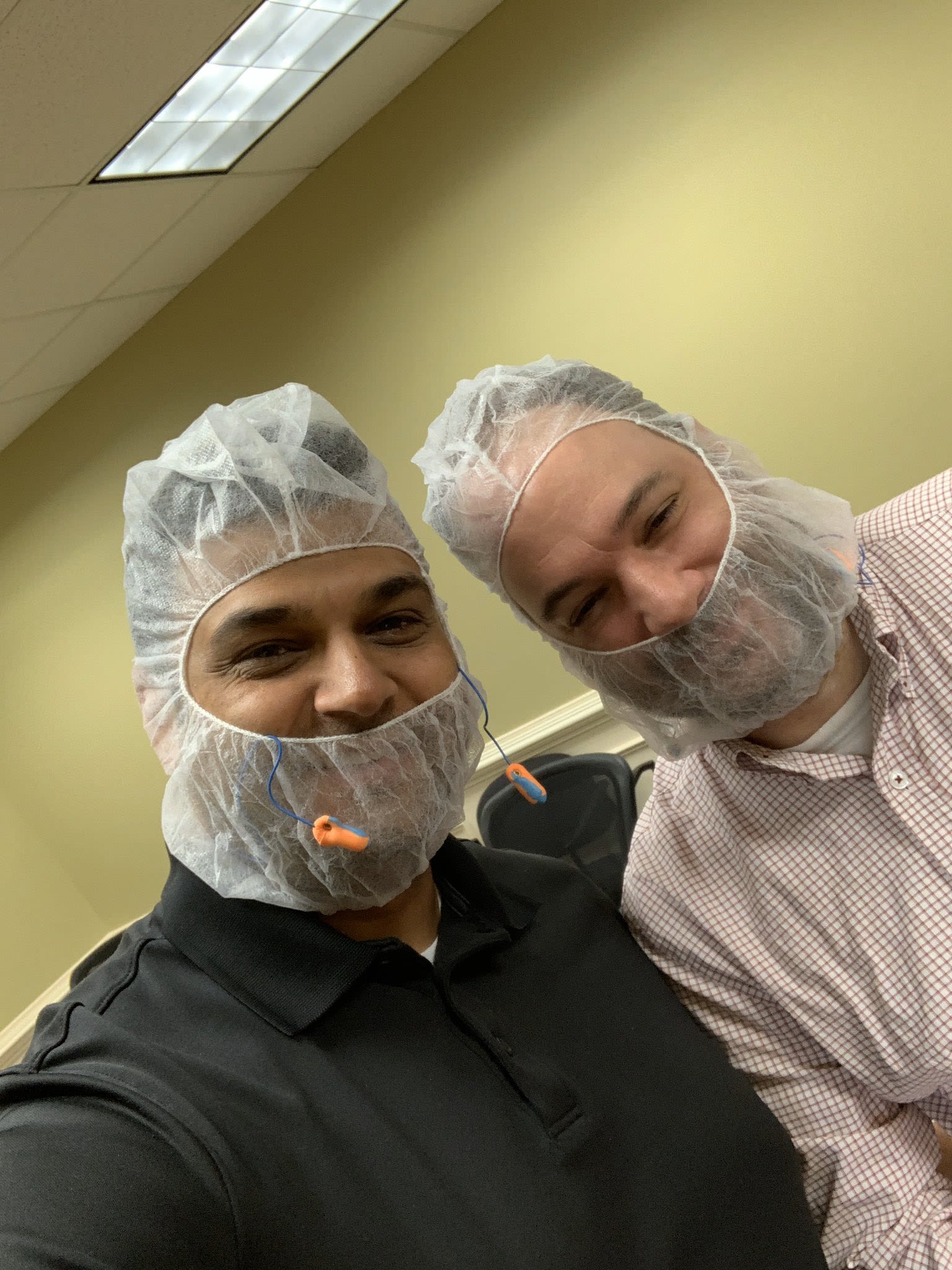 Manpreet Singh and Henk den Bakker pose wearing PPE for the lab