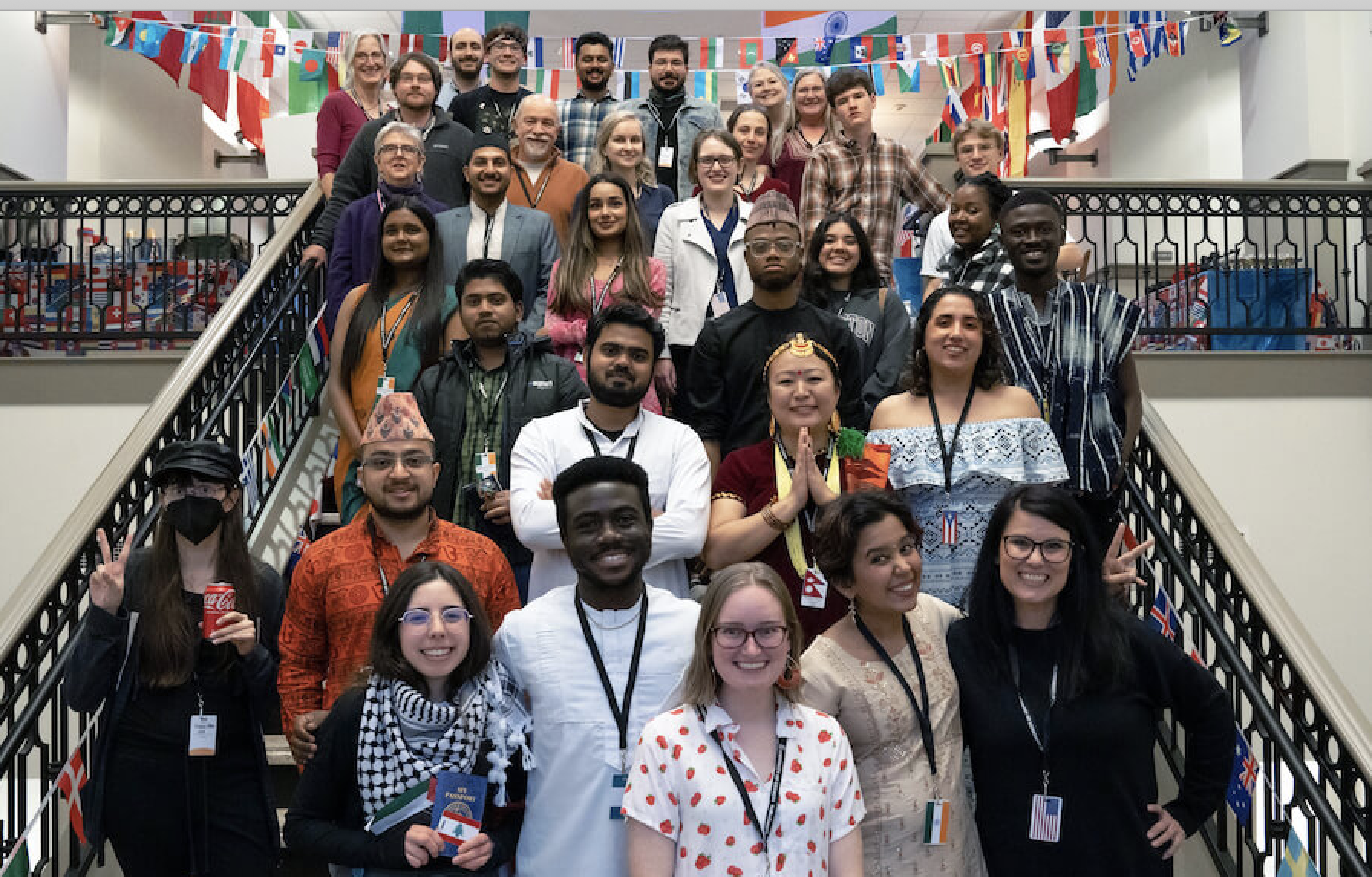 The Griffin Student Advisory Council gathers on the stairs at the campus' international potluck dinner, Taste of Nations, where many participants wore traditional clothing