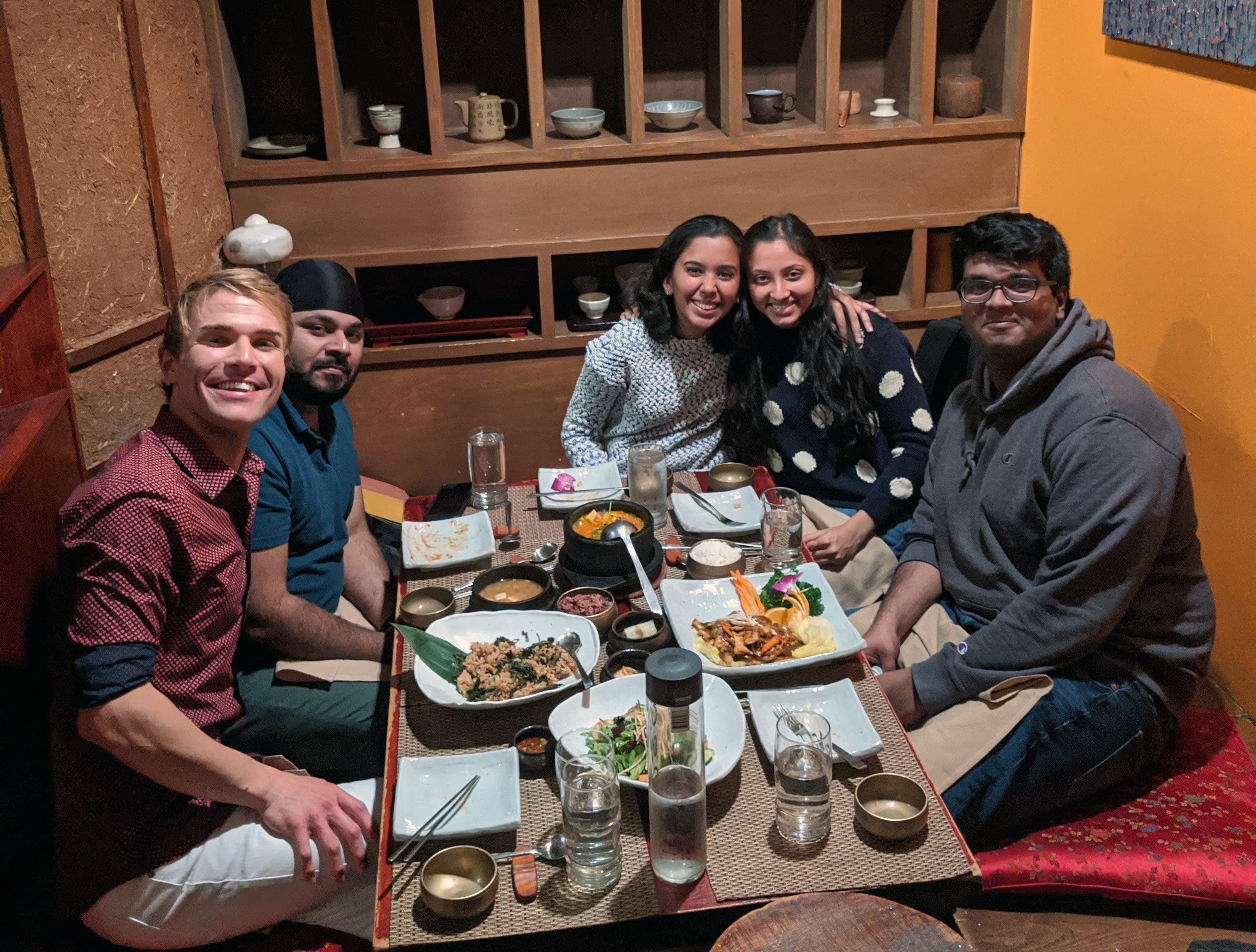 Narwankar (center) with a full table of food at lunch with four friends