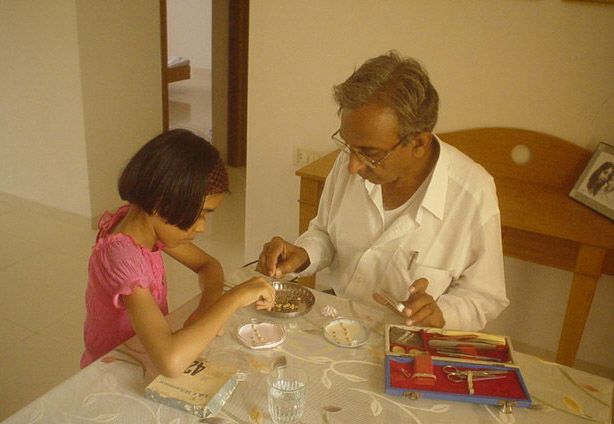 Narwankar (left) as a child working on a science project with her grandfather