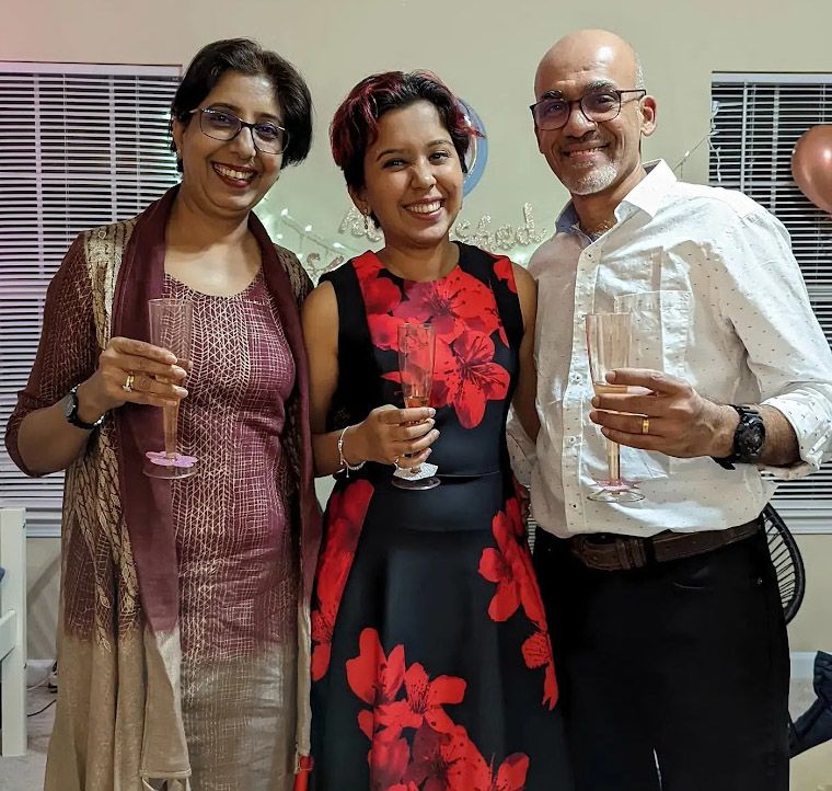 Narwankar (center) toasting with her parents