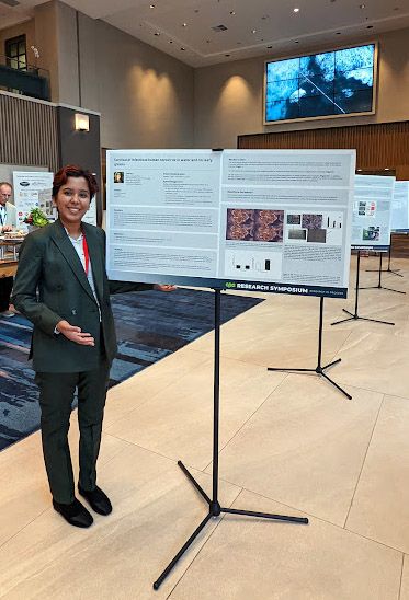 Narwankar stands next to her poster presentation at a food safety conference.