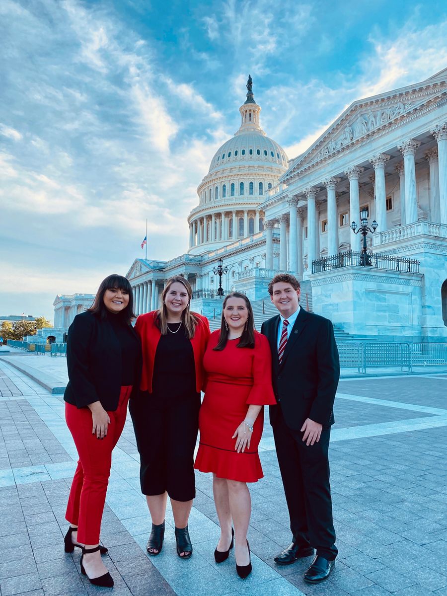 Four UGA ag fellows pose in front of the Capitol building.