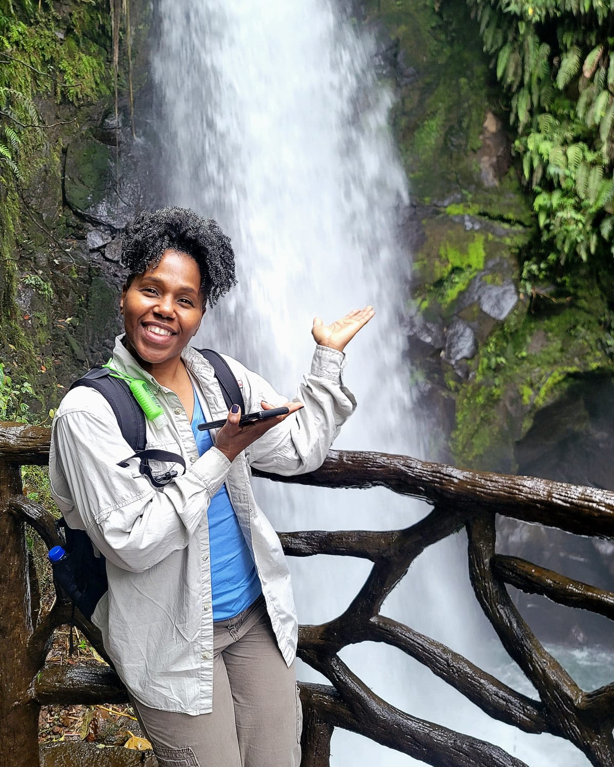 Shavannor poses in front of a waterfall