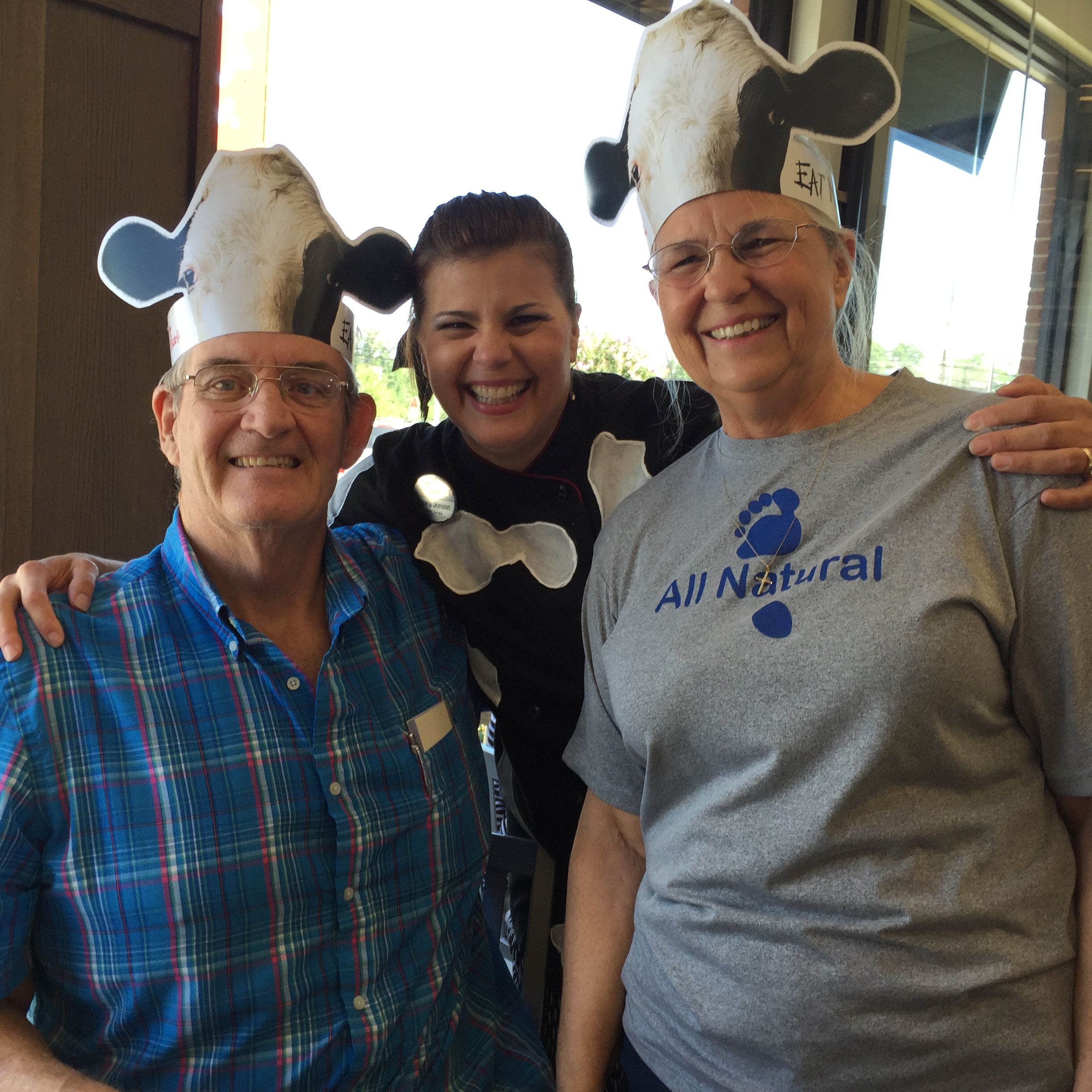 Shona Jonson and her parents pose while wearing Chick-fil-A merch.