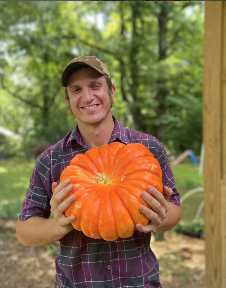 Ty Brooks smiles as he holds a pumpkin