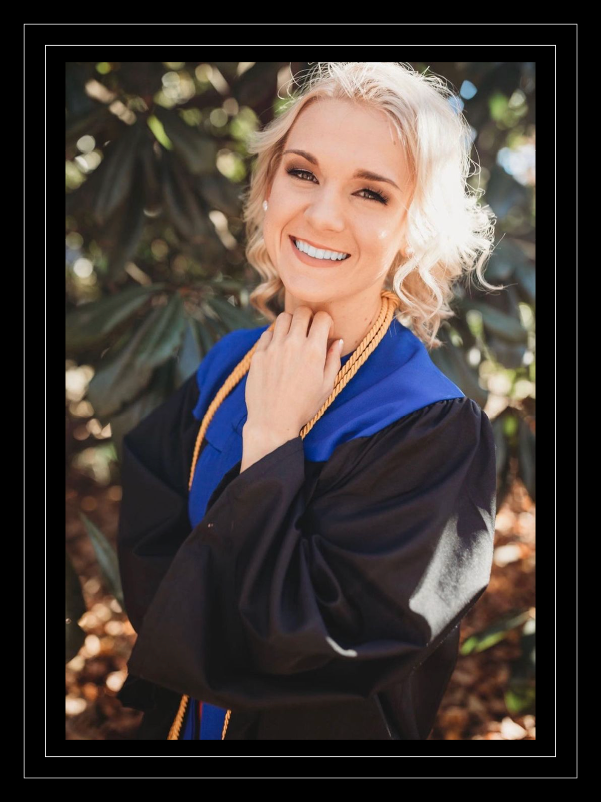 Victoria Presnal smiles in a graduation photo in which she's wearing academic regalia
