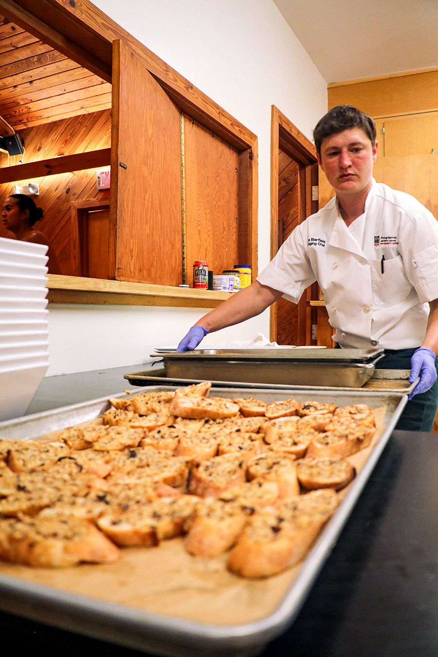A chef moves several trays with appetizers in preparation of the gala.