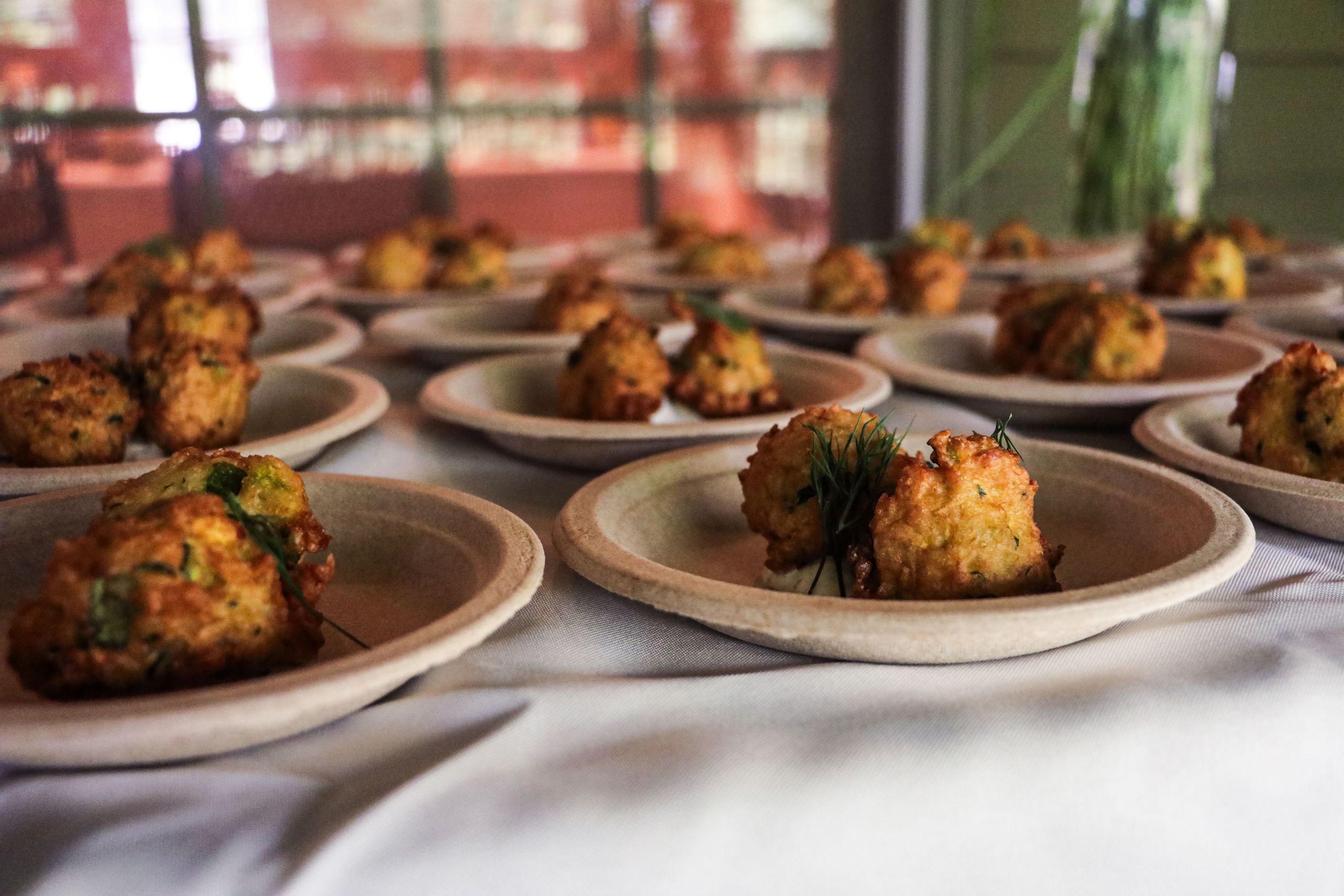 A table with plates of appetizers lined up for guests.