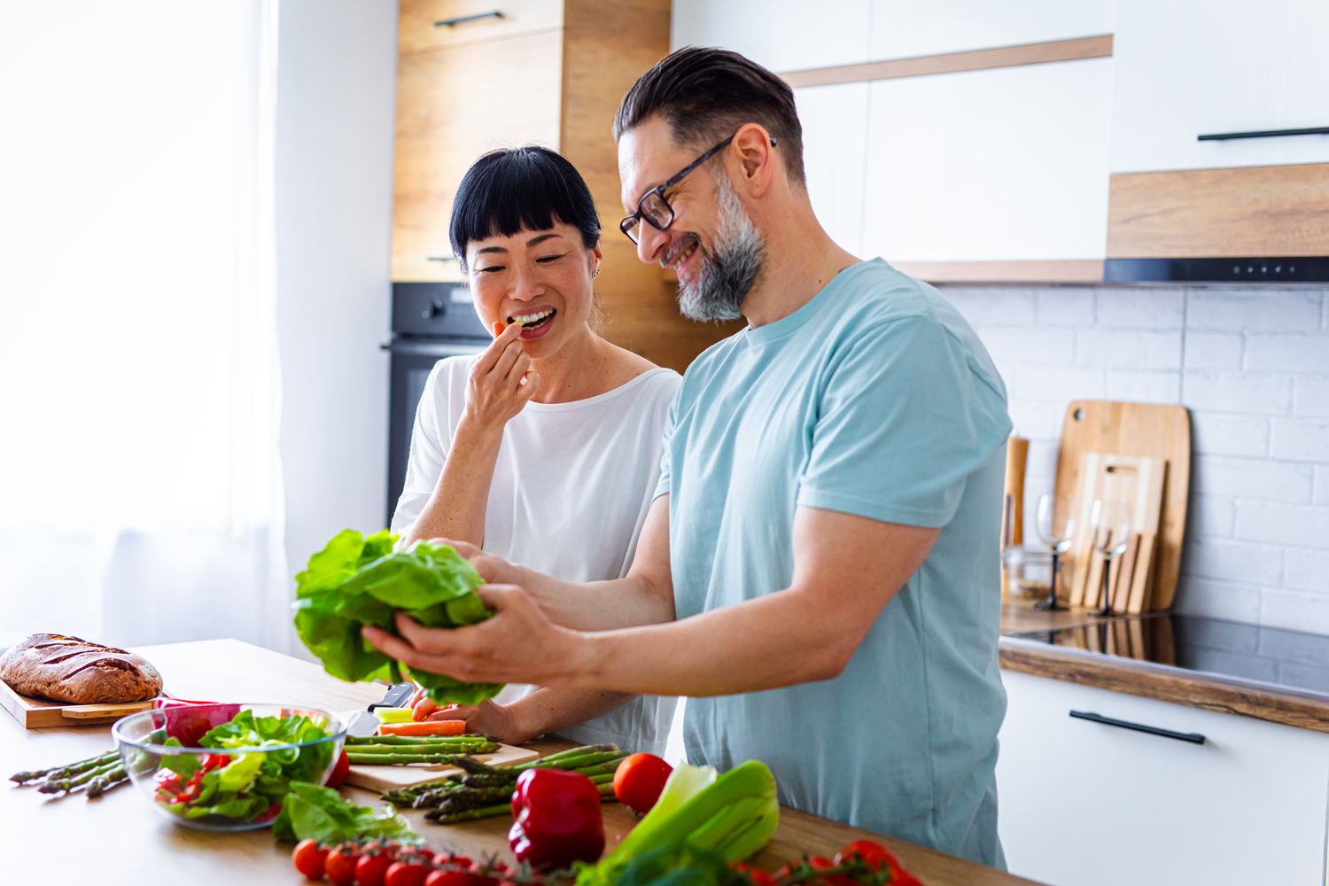 a couple makes a healthy meal together at home