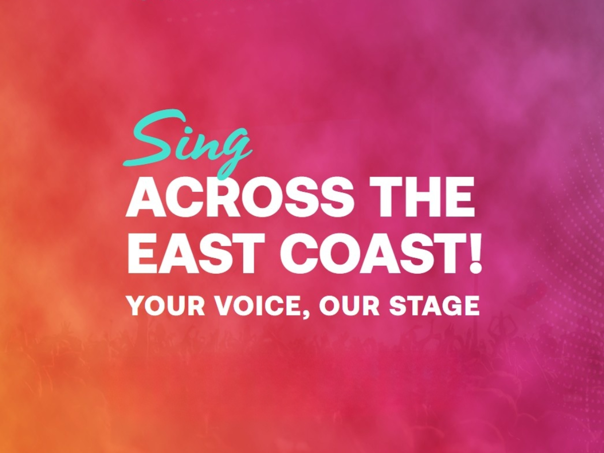 Promotional graphic with a pink‑to‑orange gradient background. Large white text reads “ACROSS THE EAST COAST!” with smaller text below, “YOUR VOICE, OUR STAGE.” The word “Sing” appears above in teal script, with a faint crowd silhouette along the bottom.