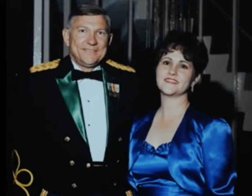 Photo of Gale Buchanan in a decorated military uniform standing beside his wife, Carol, at a formal event in Washington, D.C.