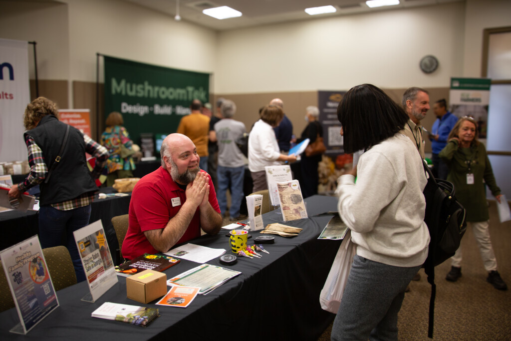 Philip Hensely, interim county Extension coordinator and ANR agent for Rockdale County, speaks with an attendee about various Extension services available to Georgians.