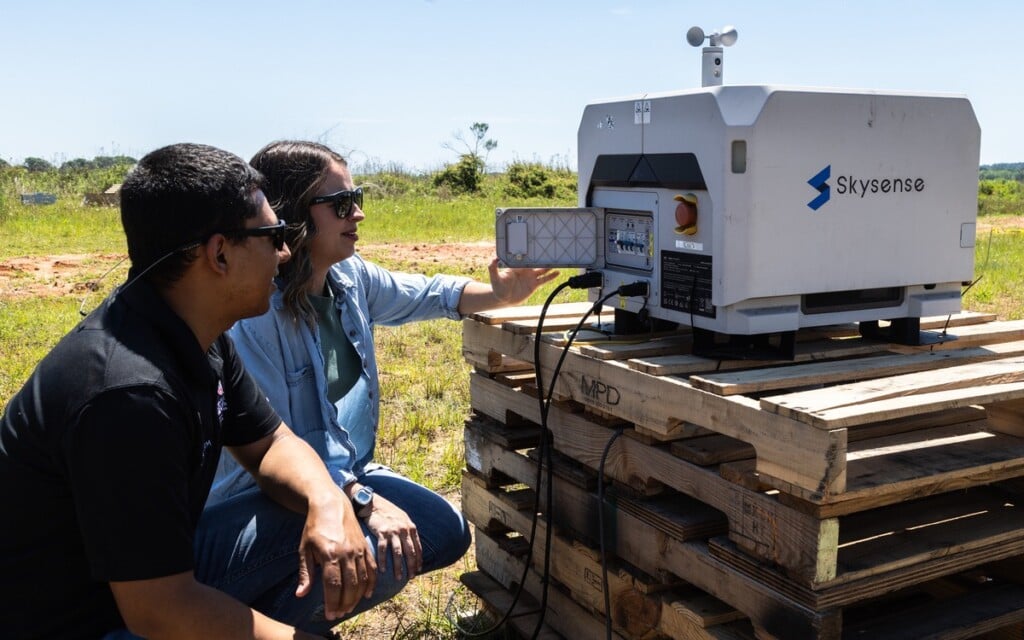 UGA Grand Farm director Lenin Rodriguez and Kaytyn Cobb look at recently delivered new technology.
