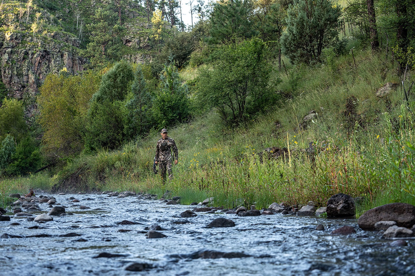 David Blanton walks next to a stream