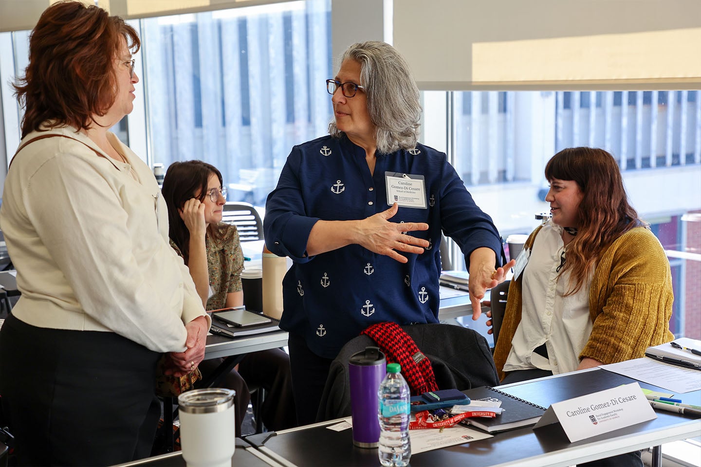 Several people engage in conversation during a workshop discussing faculty partnerships with rural communities throughout Georgia.
