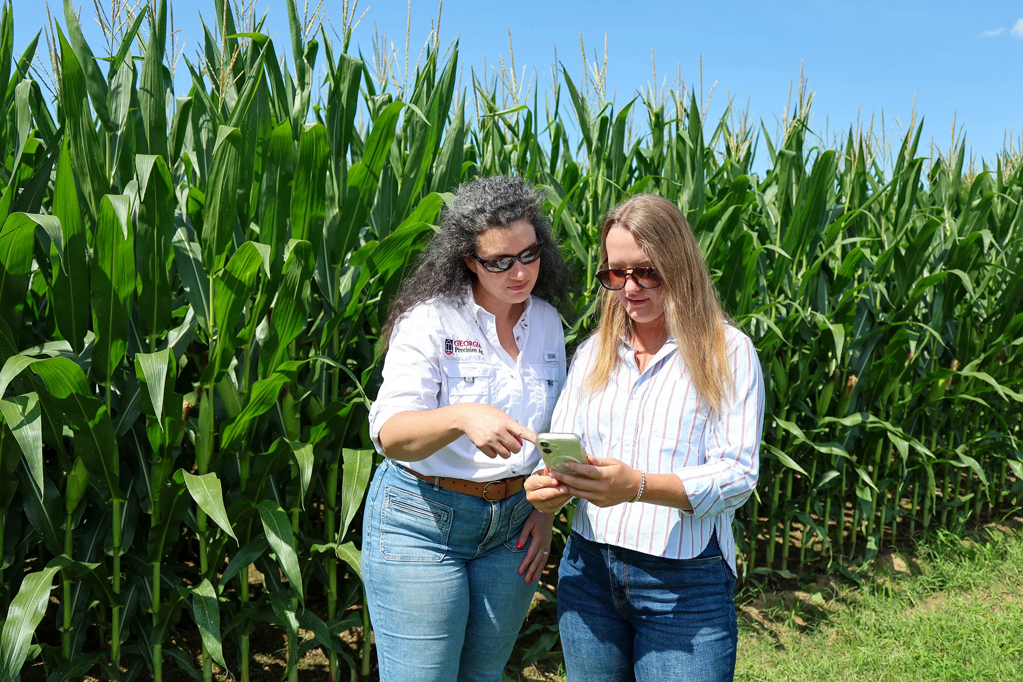 UGA Student Industry Fellow Bradley Smith, right, speaks with Lauren Lazaro, assistant professor and UGA Extension precision agriculture specialist, about FieldLog at the UGA Tifton Campus.