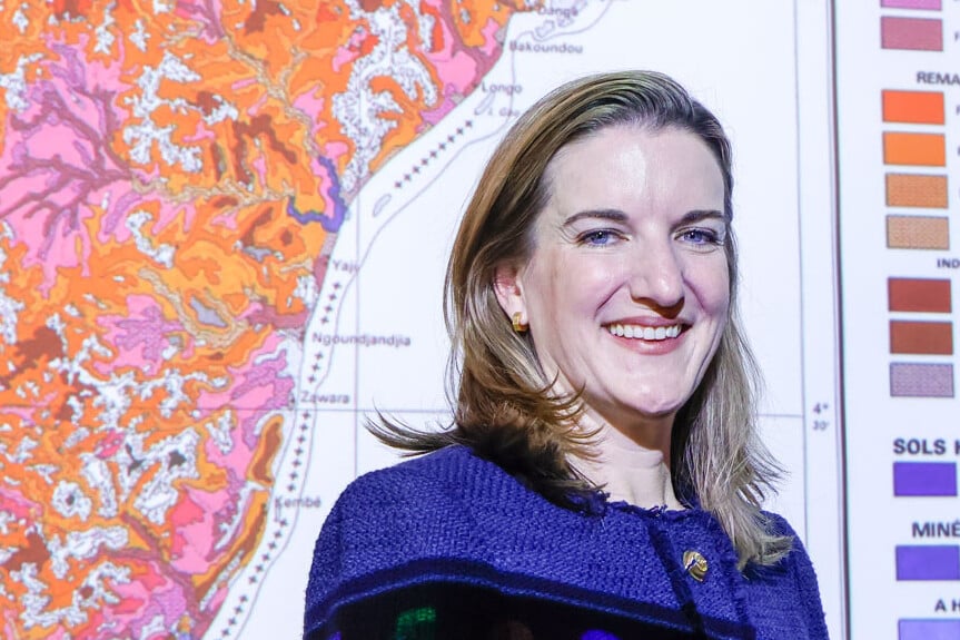 Ellen McCullough stands in front of a soil map of Africa