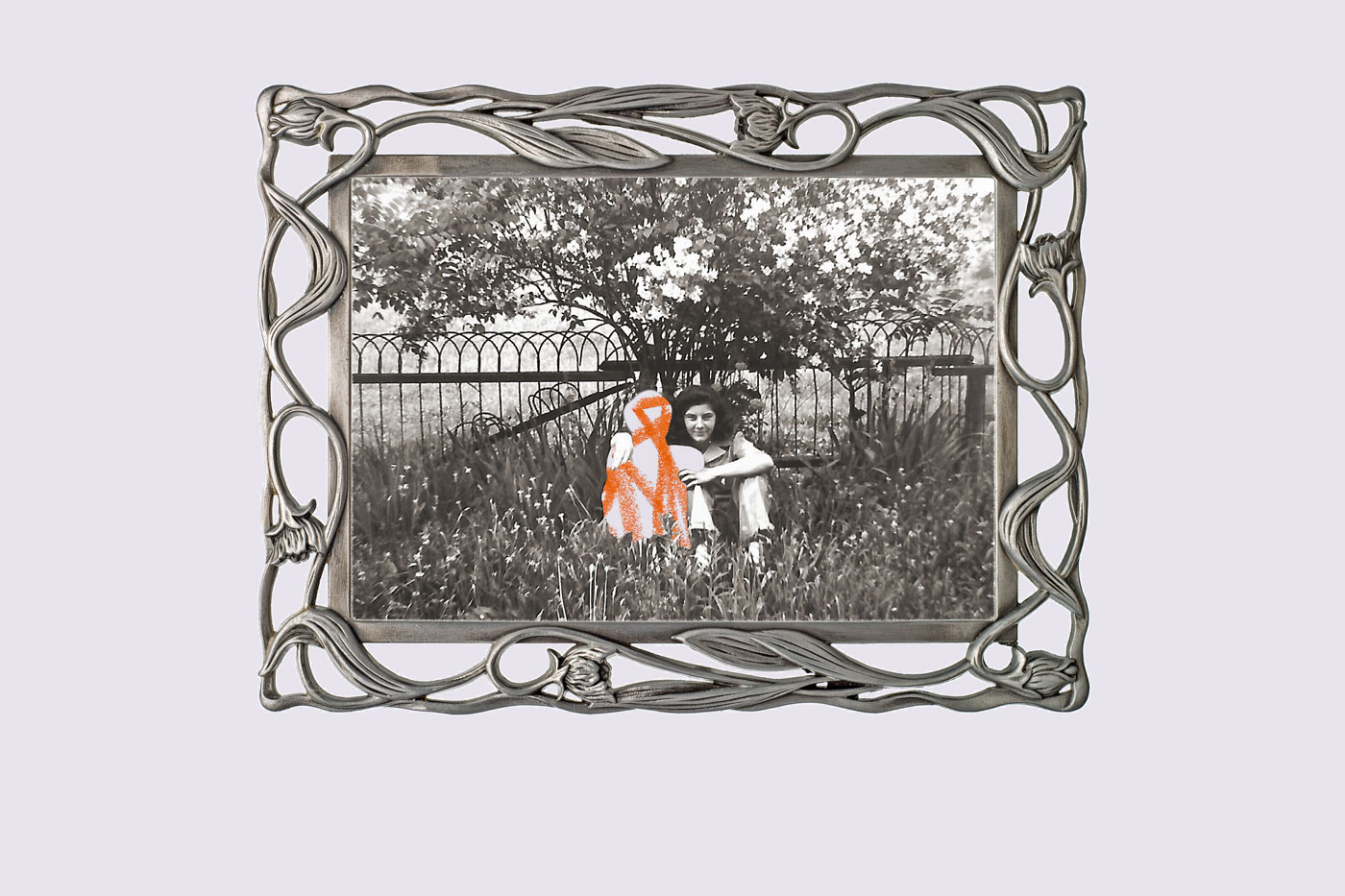 Vintage photo of two girls sitting in the grass, arms clasped around eachother, but one is missing and replaced by a scribble