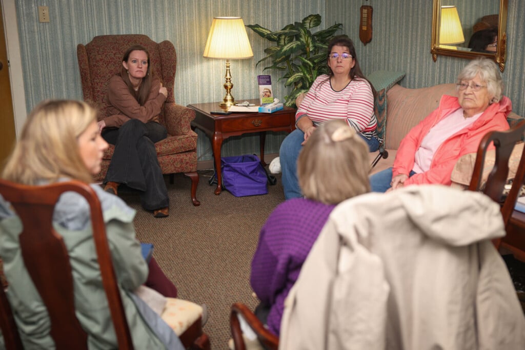 Five women in shared conversation
