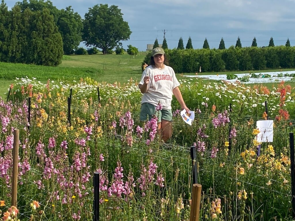 Kate Cassity-Duffey talks during a cut flower field day in the midst of rows of snapdragons.