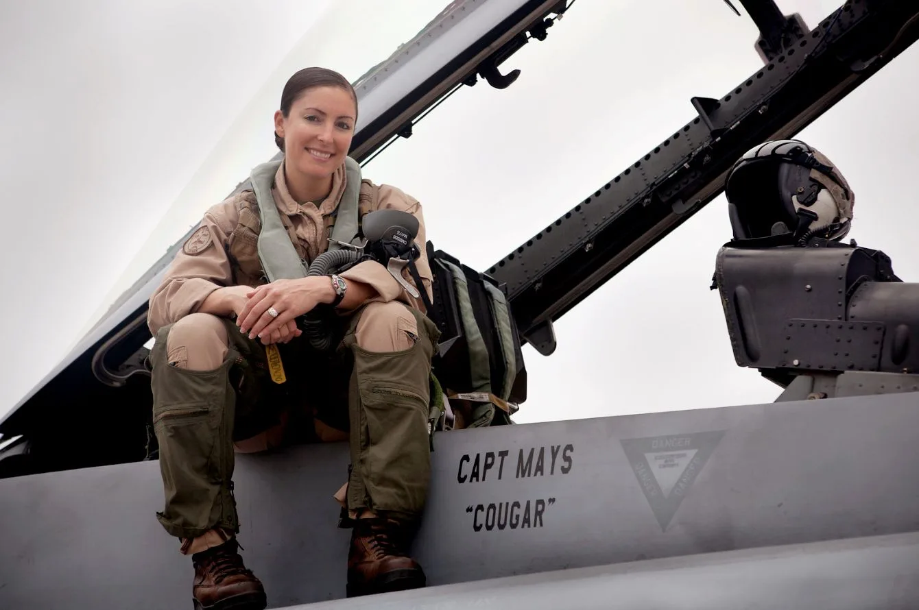 Corrie Mays in uniform, sitting on a military jet